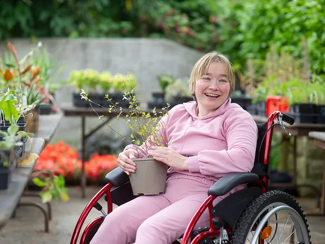 Woman in wheelchair with plants